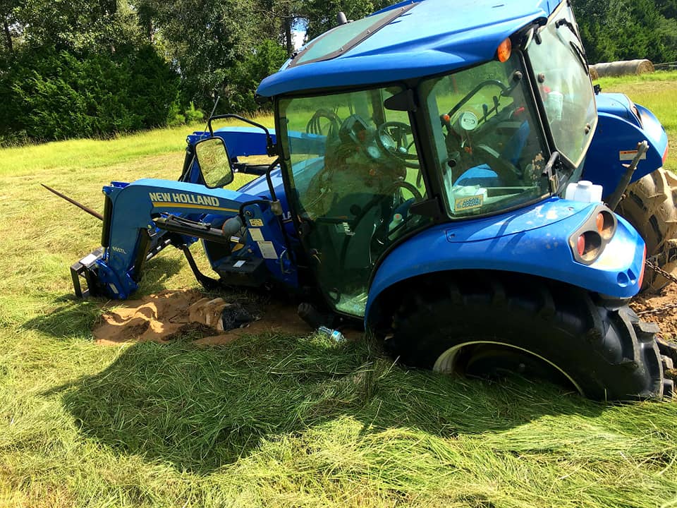tractor recovery service in Palestine TX pulling farm equipment from mud