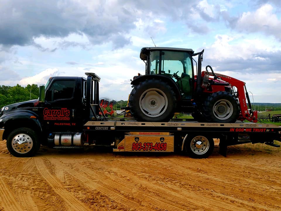 tractor towing service in Palestine TX hauling farm equipment on flatbed