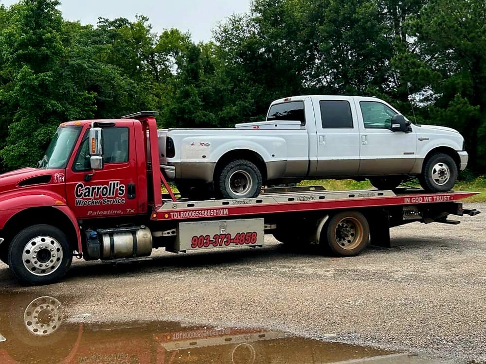 flatbed towing service in Palestine TX hauling pickup truck
